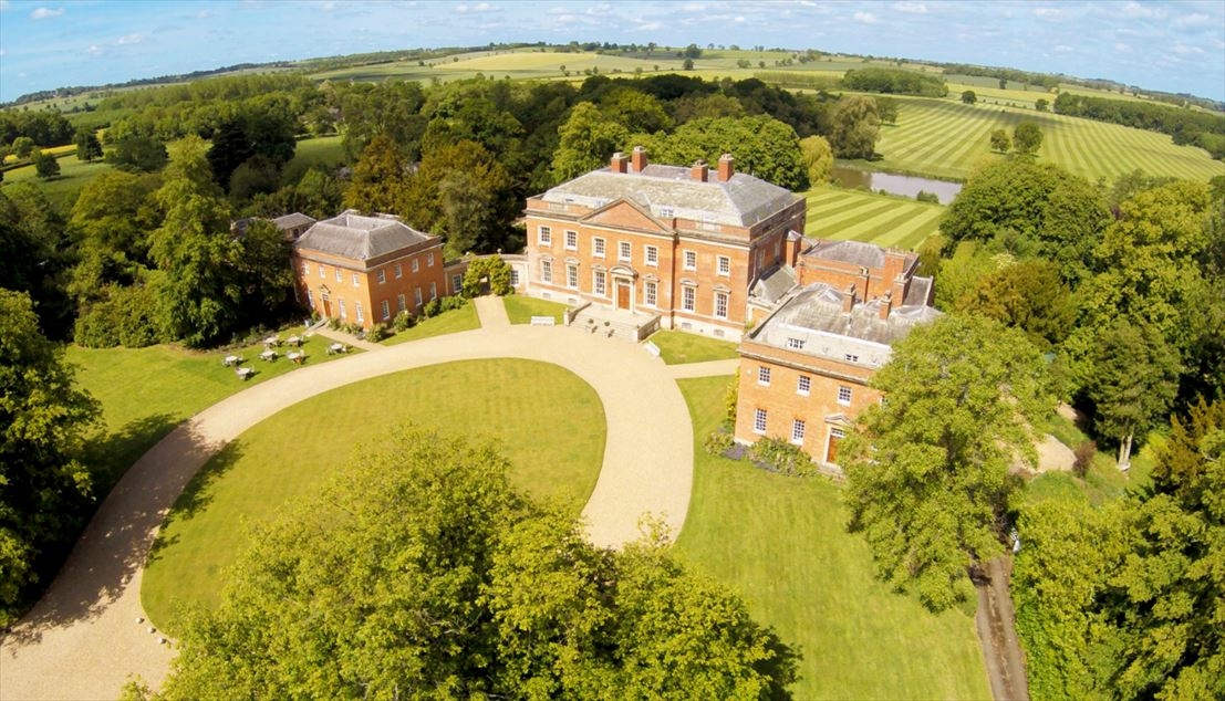 Arial view of the hall from the east, the lake and the picturesque view of the countryside.