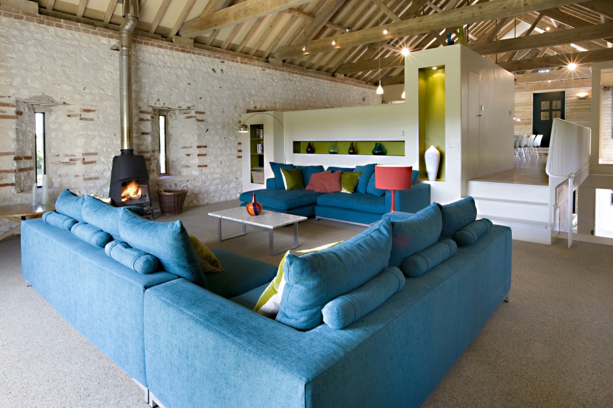 Large living area with stove in The Great East Barn