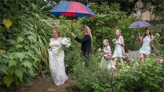 Rainy day wedding not spoiled in a beautiful garden setting